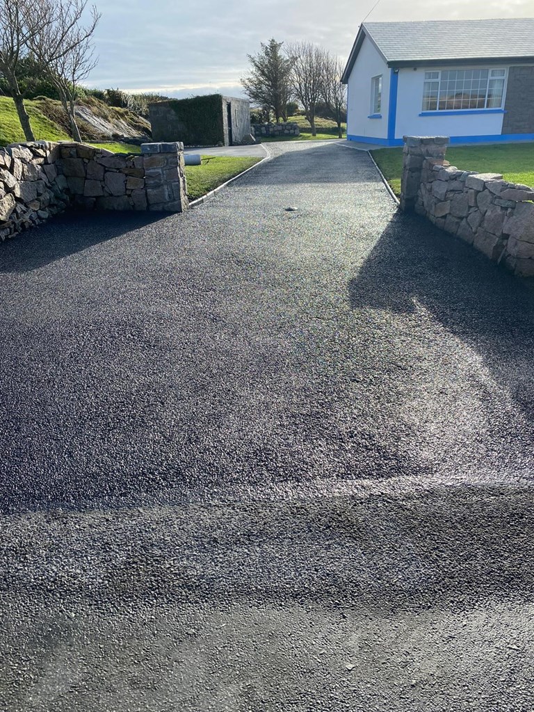 Sealed tarmac driveway leading up to a house